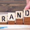 spelling "brand" with lettered blocks to reinforce Your Brand Promise in Real Estate Marketing