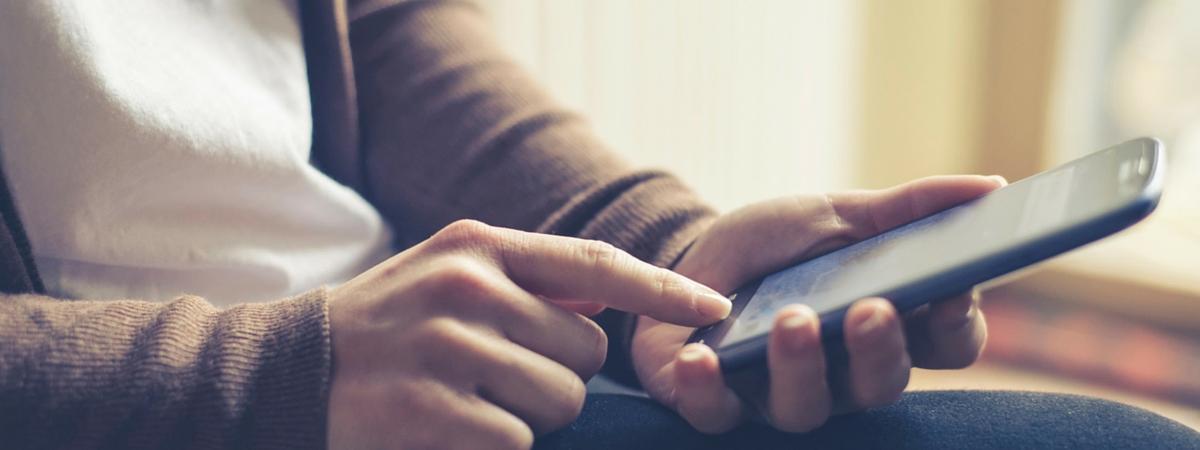 man on phone looking up Postcard Ideas for Real Estate Agents