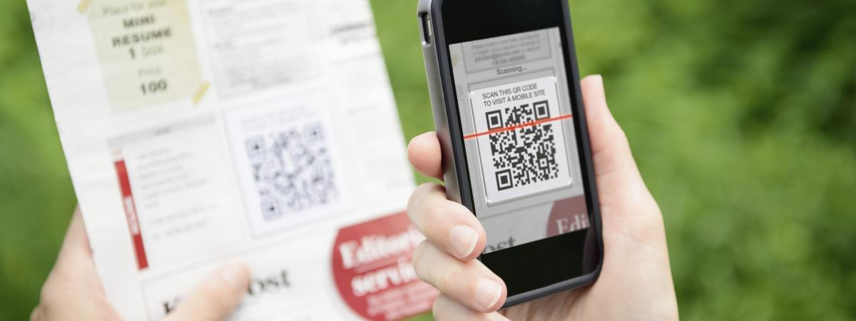 home owner scanning a qr code on a postcard