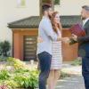 real estate agent greeting visitors during an open house